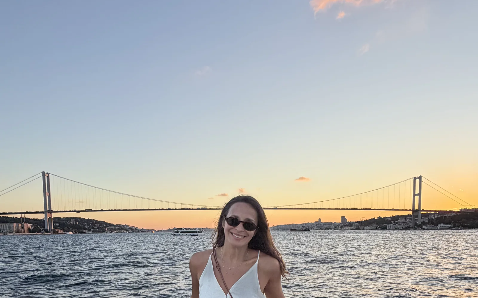 The Bosphorus at sunset seen from a private yacht, skyline glowing gold