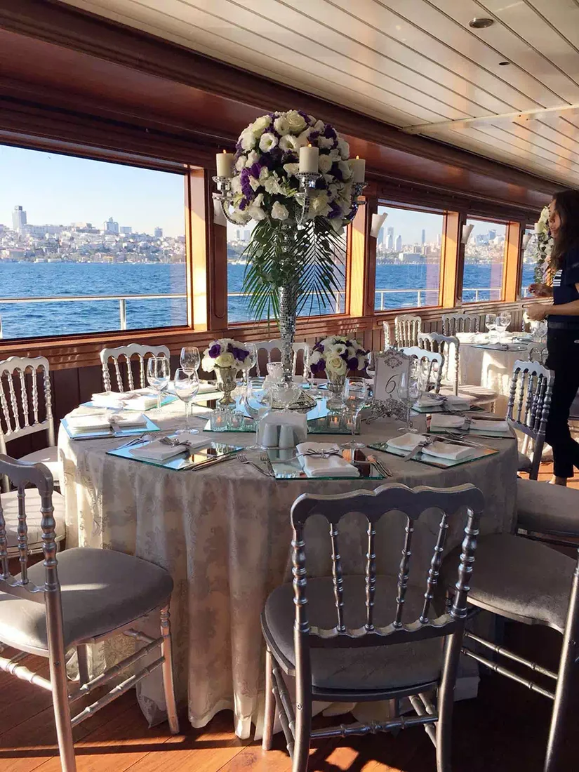 Reception table set on the deck of a yacht for a Bosphorus wedding